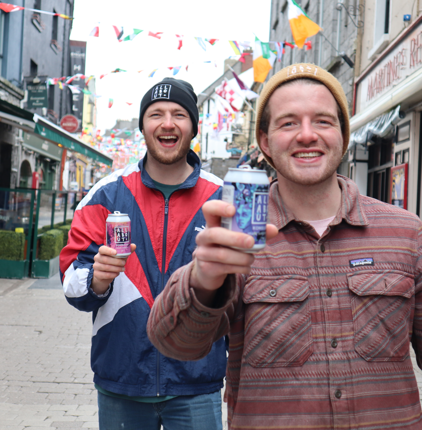 Emmett and Keith holding cans on the streets of Galway.