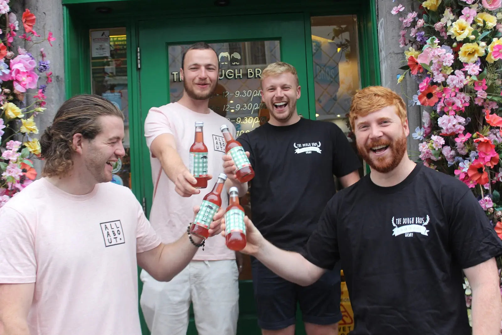 emmett and keith outside of the dough bros holding bottles of kombucha