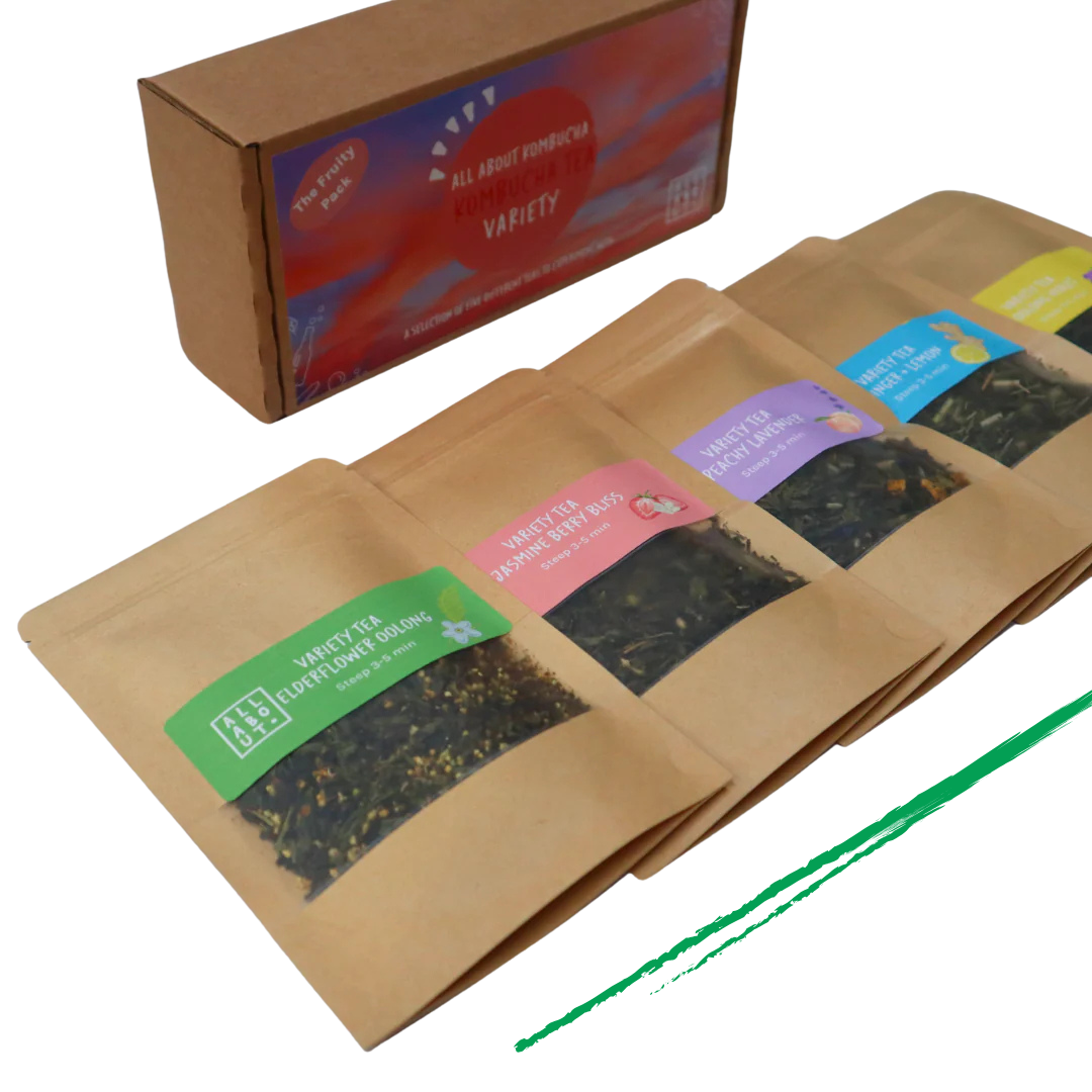 All About Kombucha tea variety pack featuring five kraft paper pouches of loose leaf tea blends, including elderflower oolong, berry bliss, and peach blossom, alongside branded packaging box.